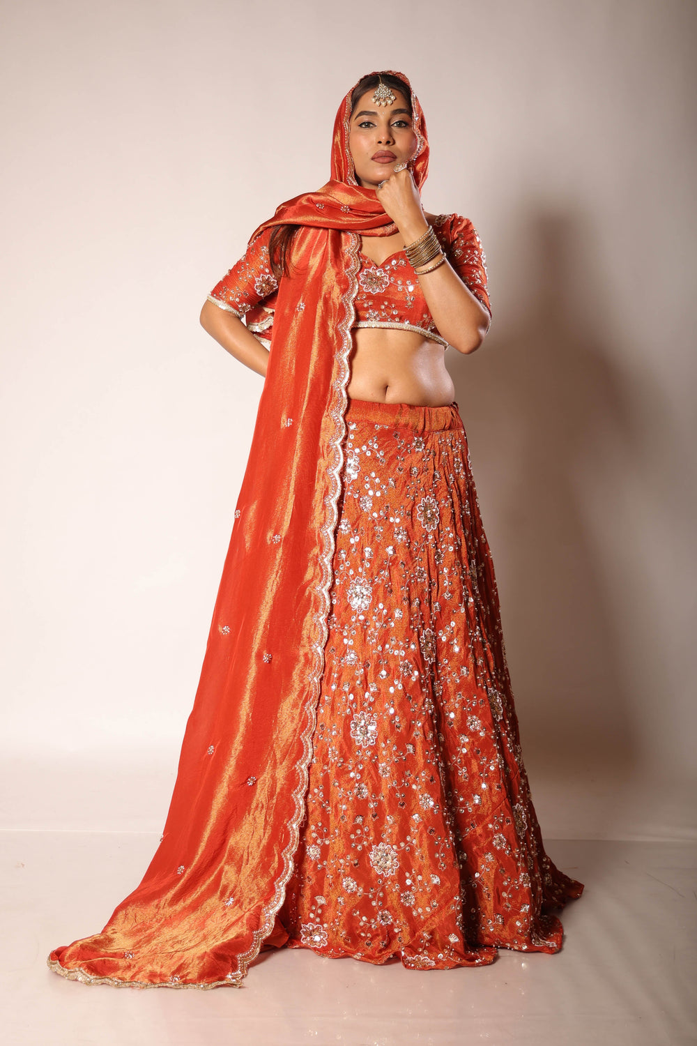 Rust embroidered lehenga set for a wedding function by Togaa